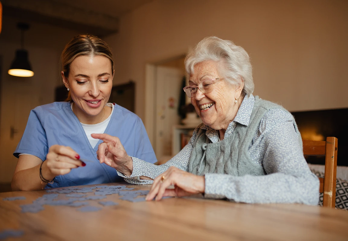 Audubon Care Homes Caregiver and senior making a puzzle