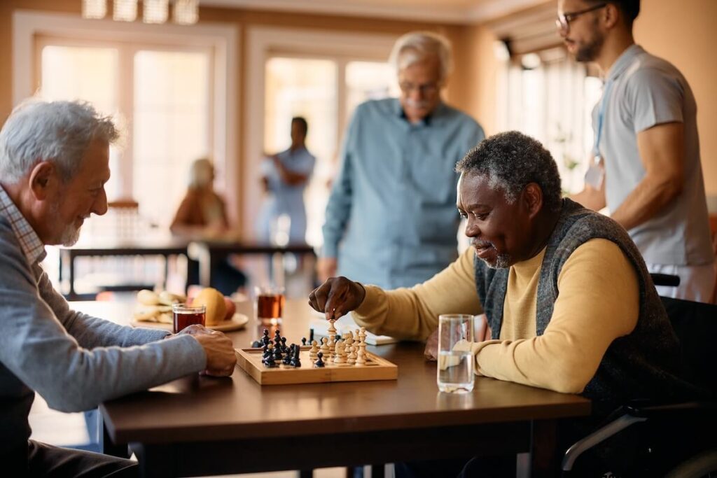 Seniors playing chess in a senior living community