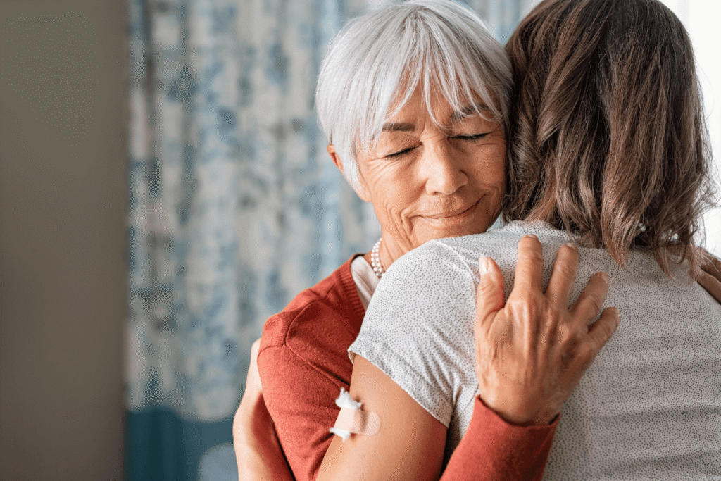 Close up of senior mother embracing adult daughter.